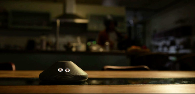 A shot from the title sequence of Kimi (2022) with googly eyes imposed on the eponymous device.